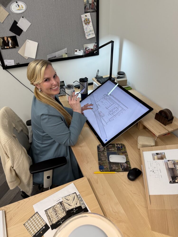 DESTRY WORKING AT COMPUTER WITH DRAWINGS