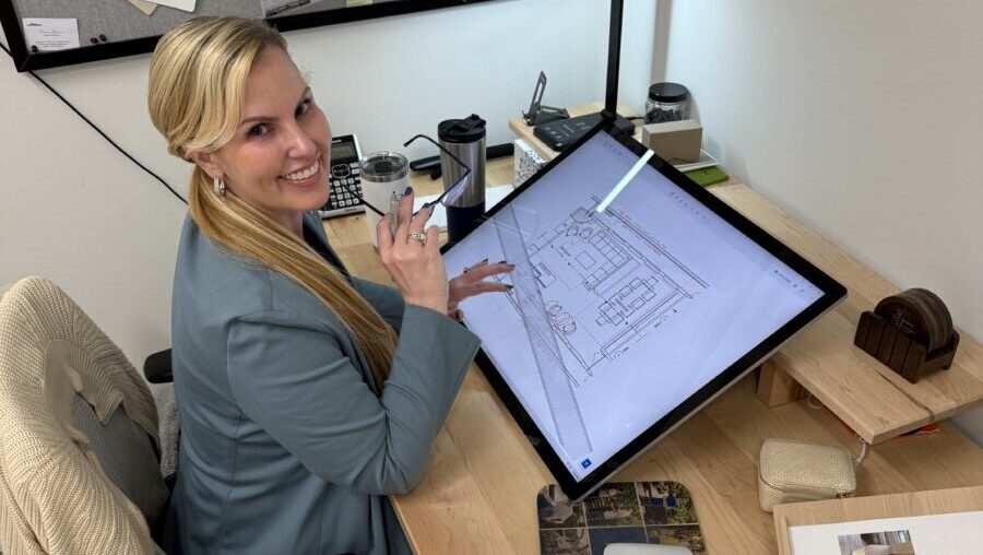 DESTRY WORKING AT COMPUTER WITH DRAWINGS